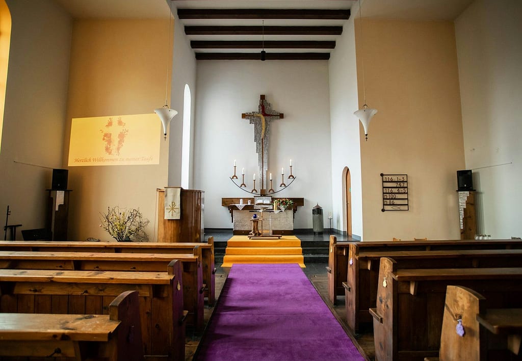 a church with pews and a cross on the wall